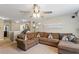 Spacious living room features a comfortable sectional sofa, ceiling fan, and carpeted flooring at 1613 Waddell Ct, Durham, NC 27703