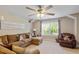 Cozy living room featuring comfortable furniture, a ceiling fan, and plenty of natural light at 1613 Waddell Ct, Durham, NC 27703