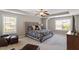 Stylish bedroom with tray ceiling, two windows, carpeted floors, and elegant decor at 1613 Waddell Ct, Durham, NC 27703