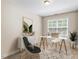 Bright office featuring a large window, white desk, stylish chair, and a decorative rug at 1613 Waddell Ct, Durham, NC 27703