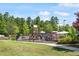 Community playground featuring multiple play structures, surrounded by lush greenery and providing recreational opportunities for children at 1613 Waddell Ct, Durham, NC 27703