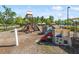 Vibrant community playground featuring climbing structures, slides, and play areas, all surrounded by protective mulch ground cover at 1613 Waddell Ct, Durham, NC 27703