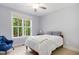 Cozy bedroom with a large window offering a serene view and an armchair for lounging at 165 Alpine Rd, Moncure, NC 27559