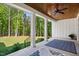 Covered patio with wooden ceiling, ceiling fan, and a view of the yard at 165 Alpine Rd, Moncure, NC 27559