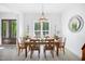 Dining room with bright window, modern chandelier and wooden table at 165 Alpine Rd, Moncure, NC 27559