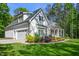 Side view of home showing attached garage and manicured landscaping at 165 Alpine Rd, Moncure, NC 27559