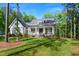 Charming white farmhouse-style home with inviting front porch at 165 Alpine Rd, Moncure, NC 27559