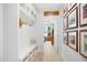 Hallway with built-in bench and storage leading into a bedroom, with framed photos adorning the wall at 165 Alpine Rd, Moncure, NC 27559