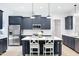 Modern kitchen with navy cabinets, stainless steel appliances, and a bright white quartz countertop island at 165 Alpine Rd, Moncure, NC 27559