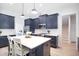 Stylish kitchen with navy blue cabinets, center island, and white subway tile at 165 Alpine Rd, Moncure, NC 27559