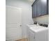 Functional laundry room with modern washer and dryer and overhead cabinets for storage at 165 Alpine Rd, Moncure, NC 27559