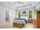 Spacious main bedroom with natural light, a tray ceiling, and an ensuite bathroom entrance at 165 Alpine Rd, Moncure, NC 27559