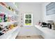 Well-lit pantry features ample shelving for storage and a window with a green view outside at 165 Alpine Rd, Moncure, NC 27559
