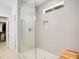 Modern walk-in shower with gray tile, a glass door, and a built-in shower niche at 165 Alpine Rd, Moncure, NC 27559