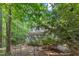 Backyard view featuring a screened in porch and lush landscaping providing privacy at 1767 Quince Loop, Sanford, NC 27332