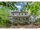Back exterior view showcasing screened porch and lush backyard creating a serene escape at 1767 Quince Loop, Sanford, NC 27332