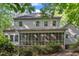 Back exterior view showcasing screened porch and lush backyard creating a peaceful retreat at 1767 Quince Loop, Sanford, NC 27332