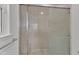 Modern bathroom features a shower with sliding glass doors and marble-look tile at 1767 Quince Loop, Sanford, NC 27332