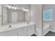Bright bathroom features dual sinks, modern fixtures, and a large mirror at 1767 Quince Loop, Sanford, NC 27332