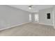 Spacious bedroom with ceiling fan and adjacent bathroom; bright and airy at 1767 Quince Loop, Sanford, NC 27332