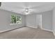 Spacious bedroom with neutral carpet, a ceiling fan, and a large window at 1767 Quince Loop, Sanford, NC 27332