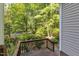 Outdoor deck offers an inviting transition to nature, surrounded by lush trees and landscaping at 1767 Quince Loop, Sanford, NC 27332