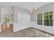 Dining area features a chandelier, windows, neutral color scheme, and white trim at 1767 Quince Loop, Sanford, NC 27332