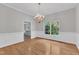 Elegant dining room featuring hardwood floors, a window with tree views, and a classic chandelier at 1767 Quince Loop, Sanford, NC 27332