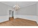 Lovely dining room with hardwood floors, classic chandelier lighting and a view into the living room at 1767 Quince Loop, Sanford, NC 27332