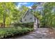 Charming two-story home with an attached garage and complemented by lush greenery and mature trees at 1767 Quince Loop, Sanford, NC 27332