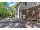 View of home showing brick foundation, garage door, and driveway surrounded by lush trees at 1767 Quince Loop, Sanford, NC 27332