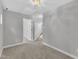 Hall area with neutral carpet and an open view of the staircase at 1767 Quince Loop, Sanford, NC 27332