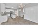 Spacious open kitchen with island, granite counters, white cabinets, stainless appliances, and tile floors at 1767 Quince Loop, Sanford, NC 27332