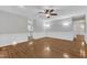 Living room features hardwood floors, a ceiling fan, and is adjacent to the kitchen at 1767 Quince Loop, Sanford, NC 27332