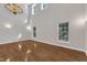 A soaring ceiling creates a dramatic feel in the living room with hardwood floors and a chandelier at 1767 Quince Loop, Sanford, NC 27332