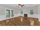 Living room with hardwood flooring, fireplace, french doors, windows, and a ceiling fan at 1767 Quince Loop, Sanford, NC 27332