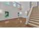 Bright living room with soaring ceilings, hardwood floors, staircase, and elegant chandelier at 1767 Quince Loop, Sanford, NC 27332