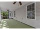 Enclosed back porch with ceiling fans offers a relaxing space with views of the surrounding trees at 1767 Quince Loop, Sanford, NC 27332