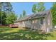 Expansive backyard featuring a well-maintained lawn, mature trees, and a spacious deck perfect for outdoor gatherings at 1998 Ferbow St, Creedmoor, NC 27522