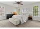 Cozy bedroom with neutral tones and large windows for ample natural light at 1998 Ferbow St, Creedmoor, NC 27522