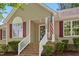 Inviting front porch featuring brick steps, white railing, and the address of the home at 1998 Ferbow St, Creedmoor, NC 27522