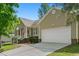 Attractive one-story home showcasing an attached garage, brick foundation, and a well-maintained driveway at 1998 Ferbow St, Creedmoor, NC 27522