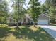Traditional home featuring a well-manicured lawn, an attached garage, and inviting curb appeal at 1998 Ferbow St, Creedmoor, NC 27522