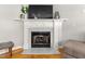 Elegant fireplace with marble surround and mantel, complemented by hardwood flooring at 1998 Ferbow St, Creedmoor, NC 27522