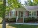 Charming home featuring a well-manicured lawn, inviting front porch, and classic architectural details at 1998 Ferbow St, Creedmoor, NC 27522