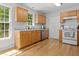 Bright kitchen with stainless steel appliances, wood cabinets, and hardwood floors at 1998 Ferbow St, Creedmoor, NC 27522