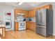 Functional kitchen featuring light wood cabinetry, modern appliances, and hardwood flooring at 1998 Ferbow St, Creedmoor, NC 27522