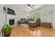 Inviting living area showcases wood floors, a cozy sectional, and a decorative fireplace at 1998 Ferbow St, Creedmoor, NC 27522
