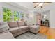 Comfortable living room with a sectional sofa, large windows, and neutral decor at 1998 Ferbow St, Creedmoor, NC 27522