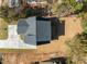 High angle drone shot of a house with a dark roof, new deck, and newly seeded lawn at 2015 Cheek Rd, Durham, NC 27704